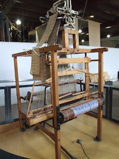 A large wooden weaving loom.